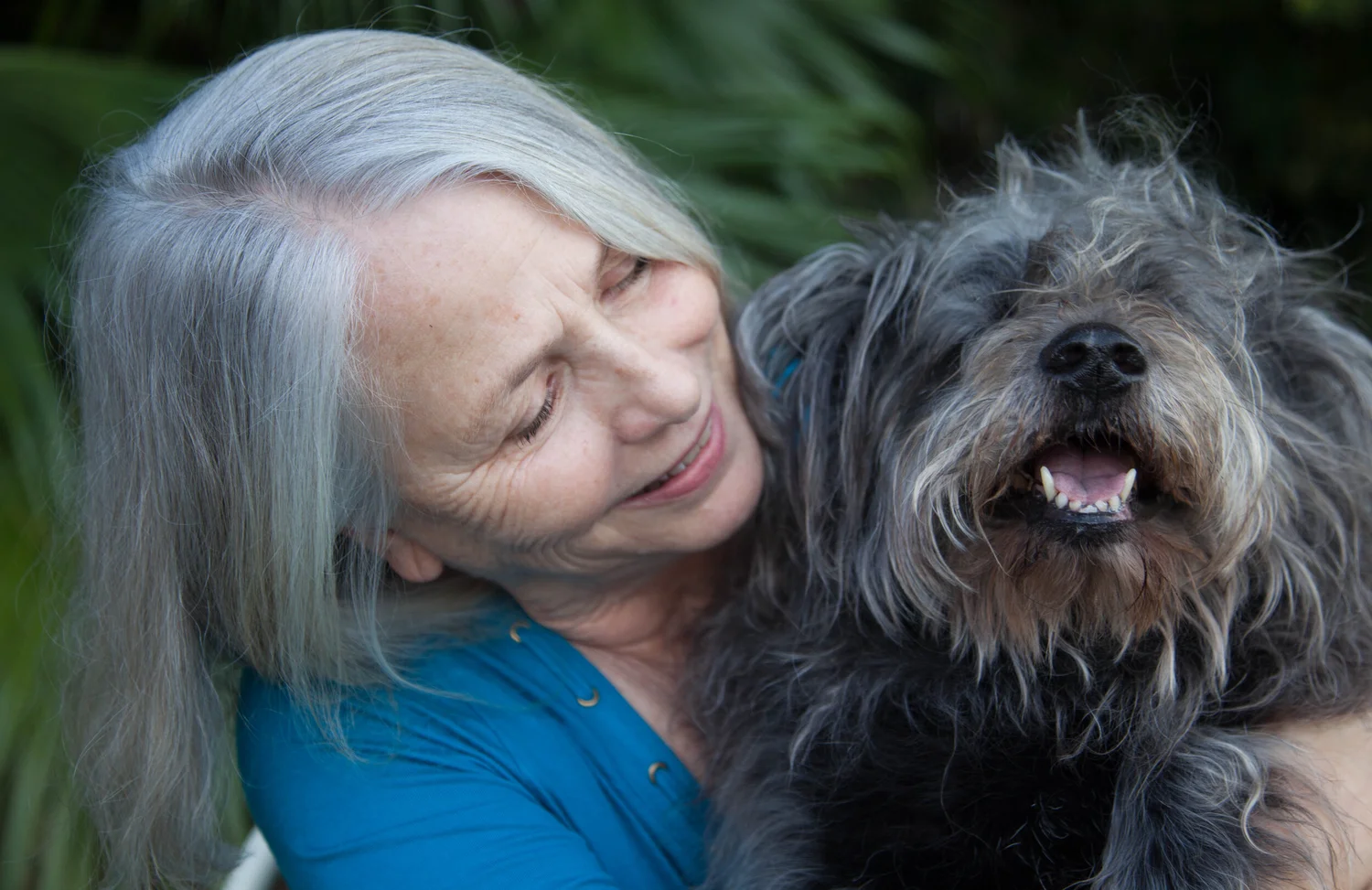 Deborah Lee Proescott holding her beloved dog Mitzvah