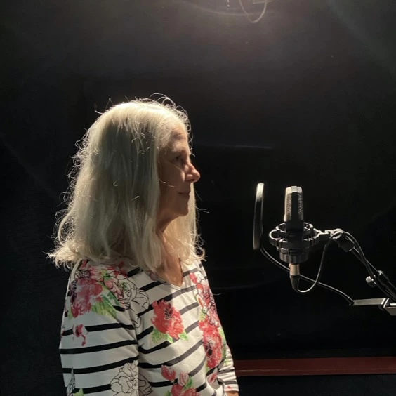 Deborah speaking into a microphone